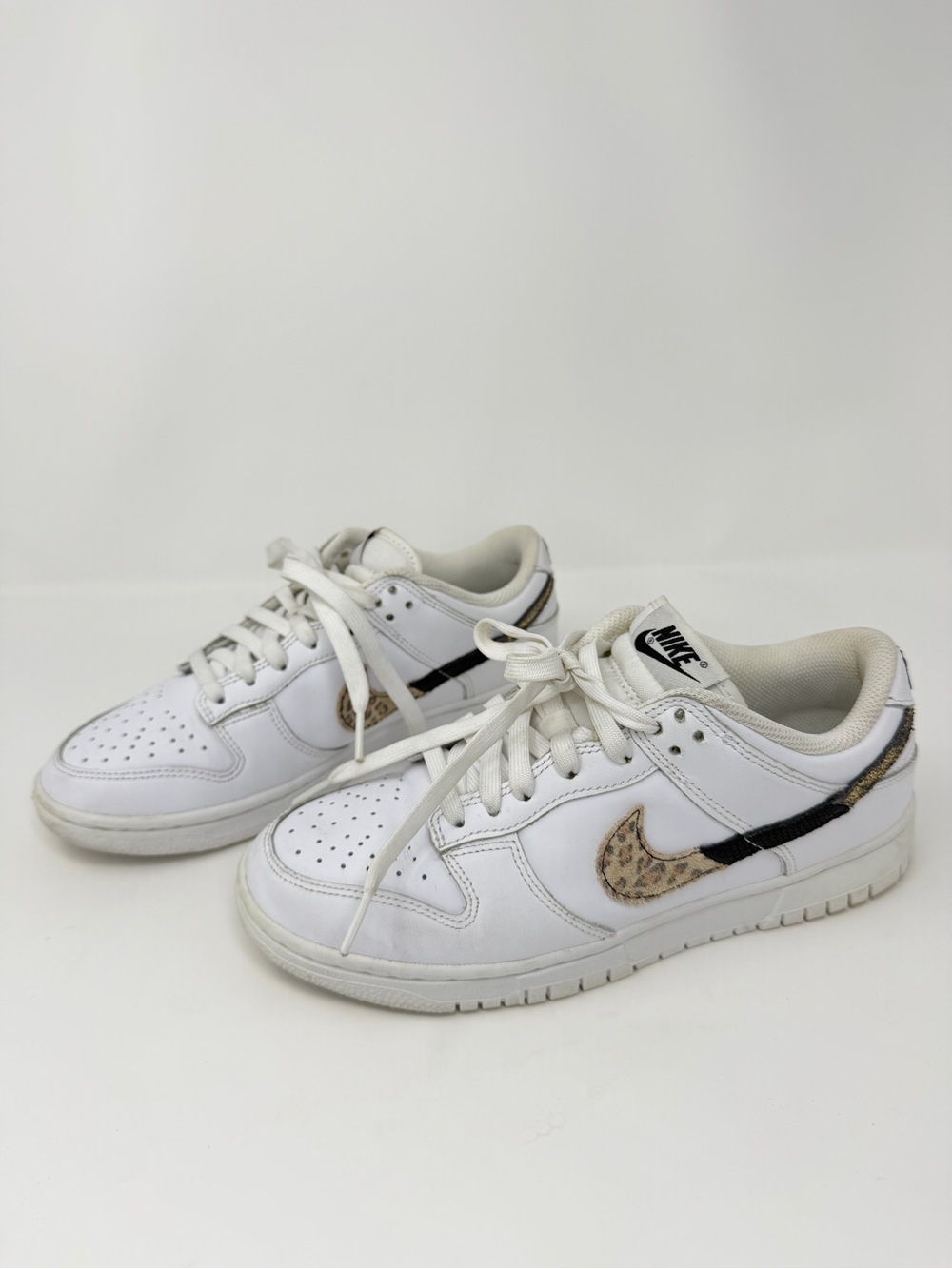 Nike Women's White Low-Top Sneakers with Leopard Swoosh and Black Accent